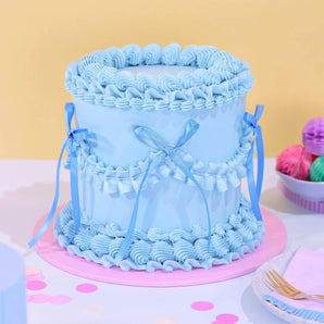 Vintage Cake - Single Colour with blue Swiss Meringue icing, 6-layer sponge, and ribbon decoration by Crumbs & Doilies.